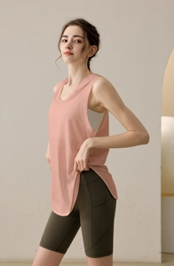 Detail of pink loose hooded tank top paired with olive green high waist biker shorts
