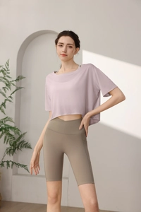 Detail view of loose lavender tencel sports tee with khaki high-waist cycling shorts