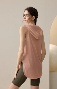 Detail view of pink loose-fit hooded sports tank top with side slits and breathable fabric