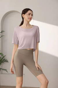 Close-up of lavender loose Tencel workout top and high-waist yoga shorts with pockets