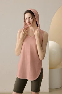 Detail of pink hooded sleeveless workout vest with curved hem and side slits for women