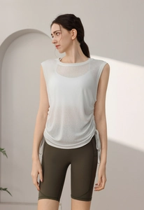 Detail of white tencel yoga top with drawstring side and olive green cycling shorts