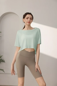 Detail of mint green Tencel workout top with cross-waist pocketed yoga shorts