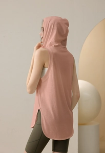 Detail shot of the side split hem on a loose hooded sports tank top for women
