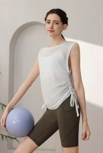 Detail of adjustable drawstring on white tencel yoga tank top with green cycling shorts
