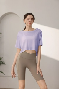 Detail view of lavender loose sports crop top and olive yoga shorts with side pocket
