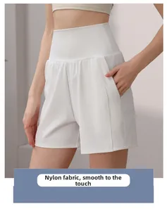 Detail of high waisted white nylon yoga shorts with functional side pockets and smooth seams