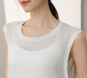 Close-up detail of white tencel yoga tank top with breathable fabric and round neck