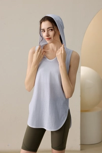 Detail of loose fit hooded yoga vest featuring side slit hem and breathable mesh fabric
