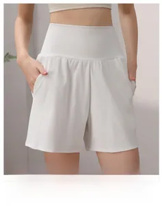 Detail of high-waisted white yoga shorts featuring a wide waistband and side pockets