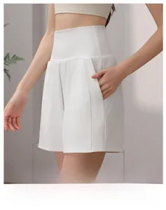 Close-up of white high-waisted yoga shorts with side pockets and quick-dry fabric