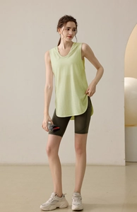 Detail of loose fit pale green hooded gym vest with breathable fabric for yoga
