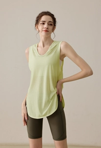 Detail of light green hooded sports vest with side slits and olive cycling shorts