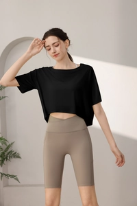 Detail of high-waisted yoga shorts with crossover waistband and side pockets