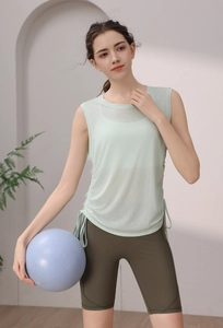Detail of mint green Tencel workout vest with adjustable side drawstrings and yoga ball