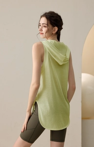 Detail view of a loose hooded fitness vest and high-waisted cycling shorts with side pocket