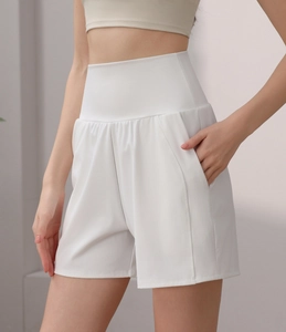 Detail view of high-waisted white yoga shorts featuring a side pocket and tummy control band