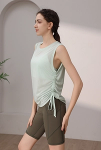 Close-up of drawstring design on loose fit yoga tank top with green cycling shorts