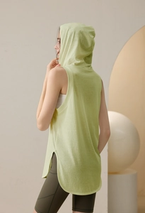 Detail view of the mint green hooded sports tank top with side slits and olive green shorts