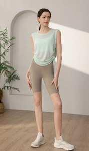 Detail of light green yoga tank top with side drawstring design and breathable fabric