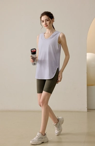 Detail view of the side split hem on a loose fit purple sleeveless hooded sports tank top