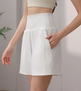 Close-up of white high-waisted yoga shorts with functional side pockets and tummy control