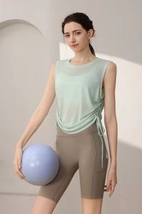 Detail of mint green breathable mesh yoga top with adjustable side drawstring