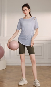 Détail du haut de yoga bleu clair avec découpe épaule et cordon de serrage latéral