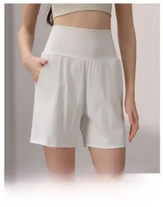 Close-up of white high-waisted fitness shorts with functional side pockets and wide waistband