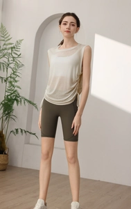 Detail of loose mesh sports vest featuring side drawstring and adjustable hemline