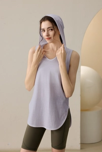 Detail view of lavender hooded sports tank top paired with olive green yoga shorts
