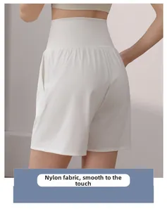 Detail of high-waisted white sports shorts in smooth nylon fabric for fitness activities