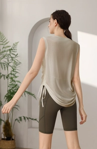 Detail of tencel yoga tank top with side drawstring and mesh fabric for fitness