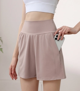 Detail view of high waisted nylon yoga shorts featuring functional side phone pockets