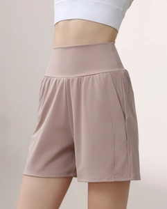 Detail of high-waisted yoga shorts in dusty rose showing wide waistband and side seams