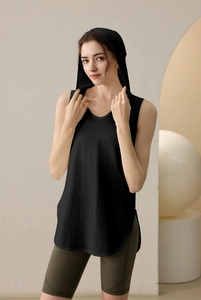 Detail view of black sleeveless hooded gym vest with side slit and curved hem for women