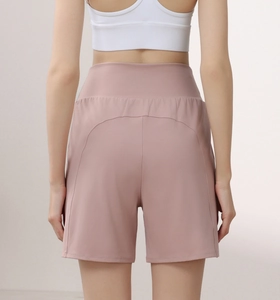 Detail view of pink high-waisted yoga shorts showing back fit and premium nylon texture