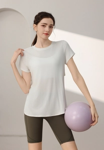 Detail of breathable white modal yoga top with olive green high-waisted cycling shorts