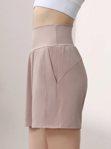Detail shot of high-waist yoga shorts in dusty rose featuring a side pocket and seam stitch