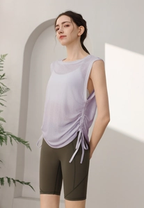 Detail of lavender drawstring sports vest and olive green high waist yoga shorts