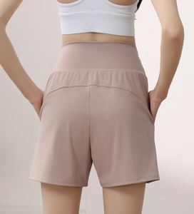 Close-up of high-waisted nylon yoga shorts showing slimming back seams and side pockets