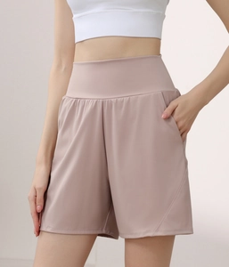 Detail view of high-waisted pink sports shorts with loose fit and side pocket