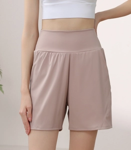 Detail of high waisted compression yoga shorts with side pockets and quick-dry fabric texture