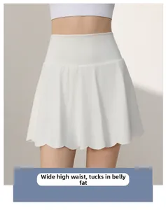 Detail of high waisted white sports skirt featuring tummy control and wavy hemline