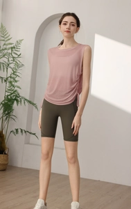Close-up of lightweight yoga tank top with side drawstring and olive green cycling shorts