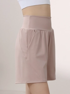Side view of high-waisted mauve yoga shorts with pockets for fitness and running