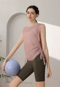 Detail of drawstring sleeveless yoga top and olive green high waist fitness shorts