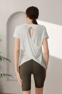 Detail of white modal sports tee featuring an elegant crisscross open back design