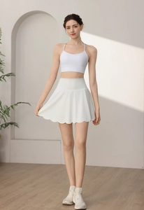 Detail of white tennis skirt with high waist petal hem and matching sports top