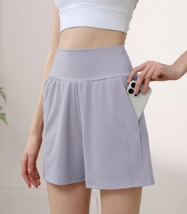 Close-up of high-waisted yoga shorts in light purple featuring side phone pockets